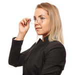Person wearing Tommy Hilfiger Gray Unisex Glasses Frame, showcasing stylish full-rim square design in multicolor metal and plastic.