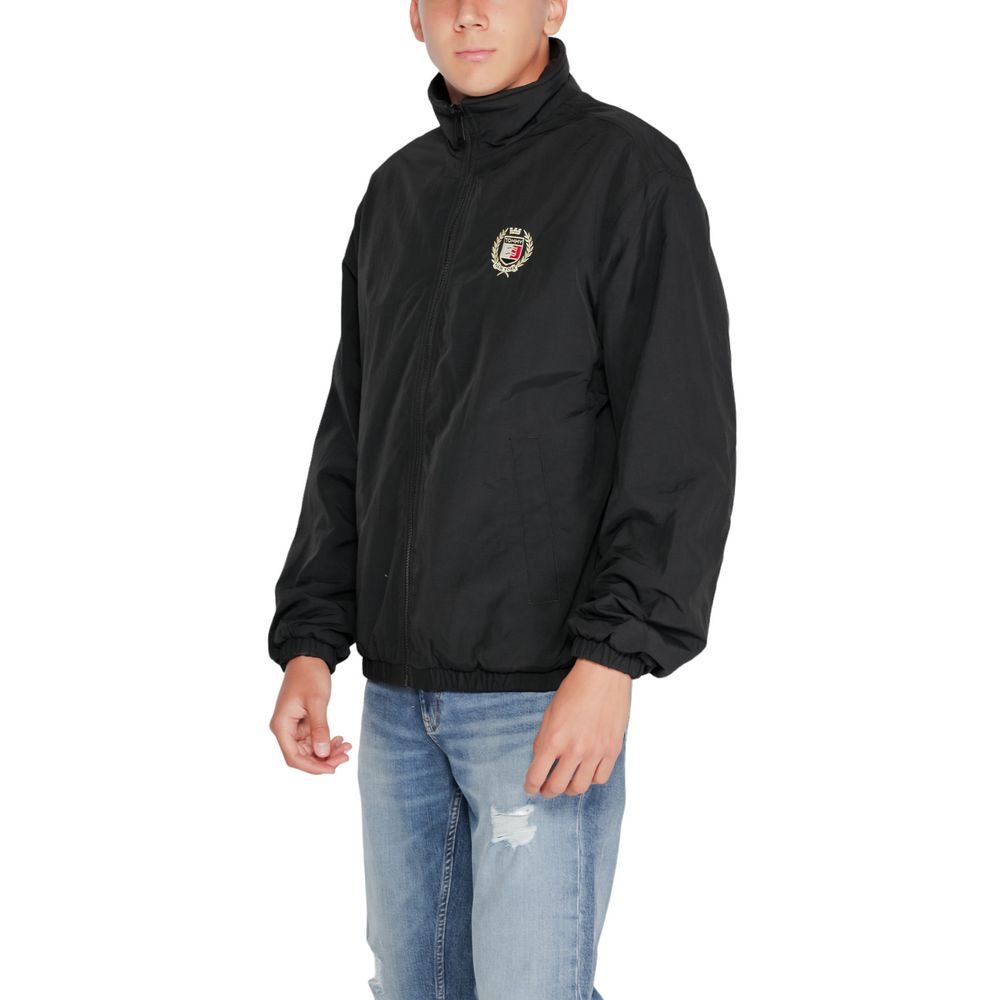 Tommy Hilfiger Jeans Black Recycled Polyester Shell Jacket with embroidered crest, worn by a model in casual style.