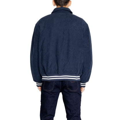 Rear view of man wearing Tommy Hilfiger Jeans Blue Recycled Polyester Jackets And Coat with ribbed cuffs.