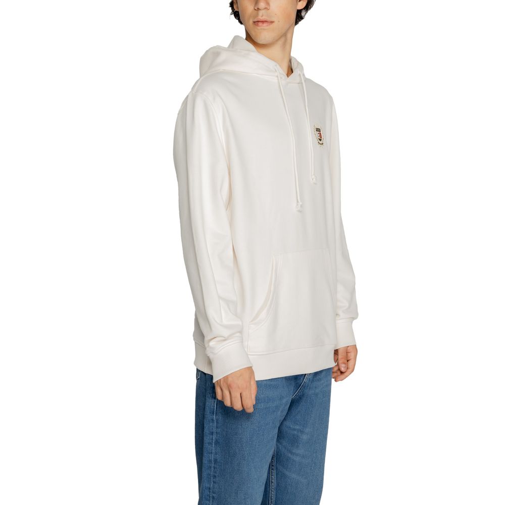 Model wearing Tommy Hilfiger Jeans White Cotton Hoodie with kangaroo pocket and drawstring hood, showcasing casual style.