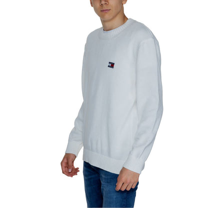 Man wearing Tommy Hilfiger Jeans White Cotton Sweatshirt with embroidered badge, crewneck and ribbed details, casual refined style.