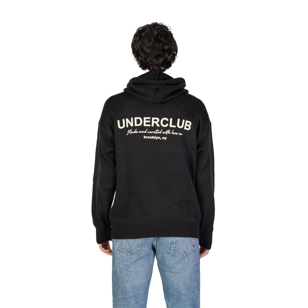 Man wearing the Underclub Black Cotton Sweater with hood and ribbed cuffs, displaying back view, text "Brooklyn, NY" visible.