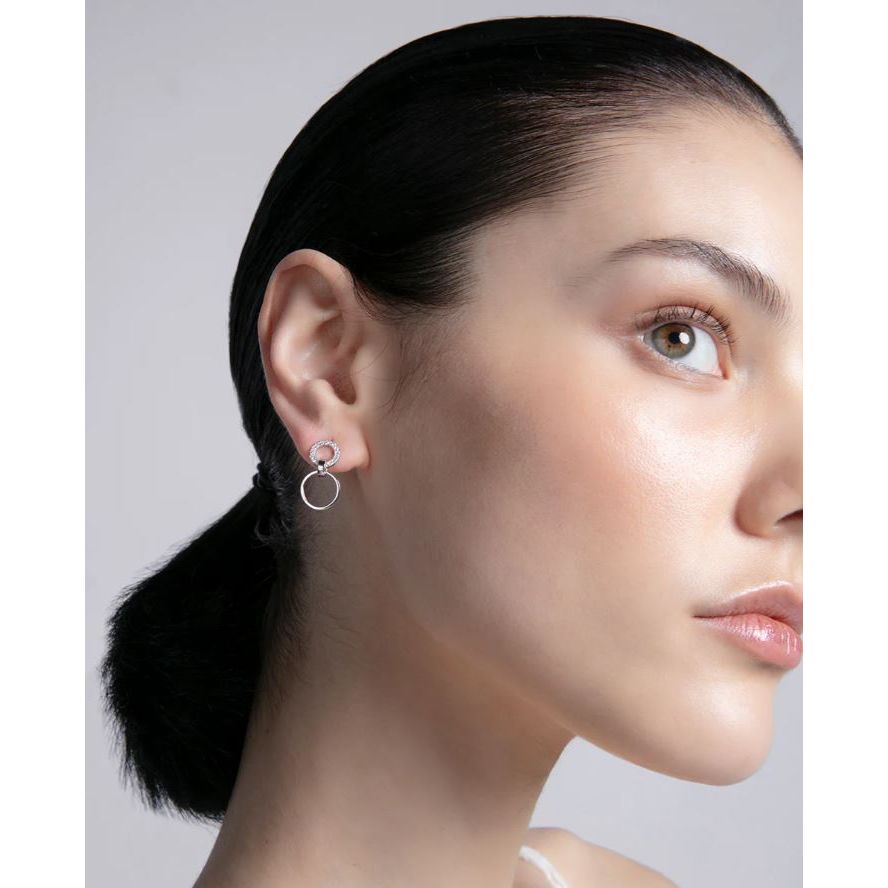 Close-up of a woman wearing VICEROY JEWELS Mod. 13214E000-30 silver earrings, showcasing elegant design and craftsmanship.