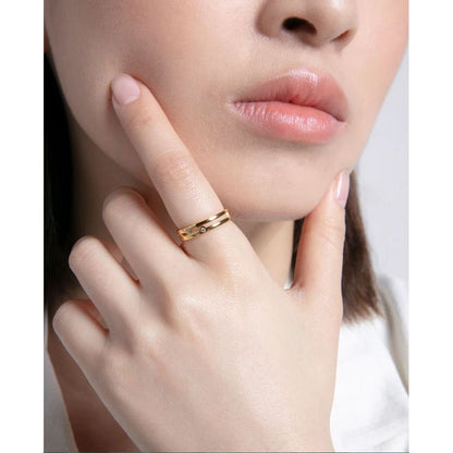Woman wearing a stylish gold ring, showcasing fine craftsmanship and elegance. Perfect accessory for any occasion.