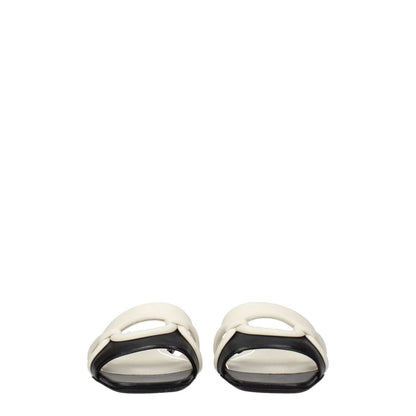 Valentino Garavani Black Leather Slippers with open toe and flat heel, featuring ivory accents, casual style, and leather sole.