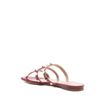 Valentino Garavani Rockstud three-strap sandals in red calf leather with flat sole and stud embellishments, open toe design, heel 1 cm.