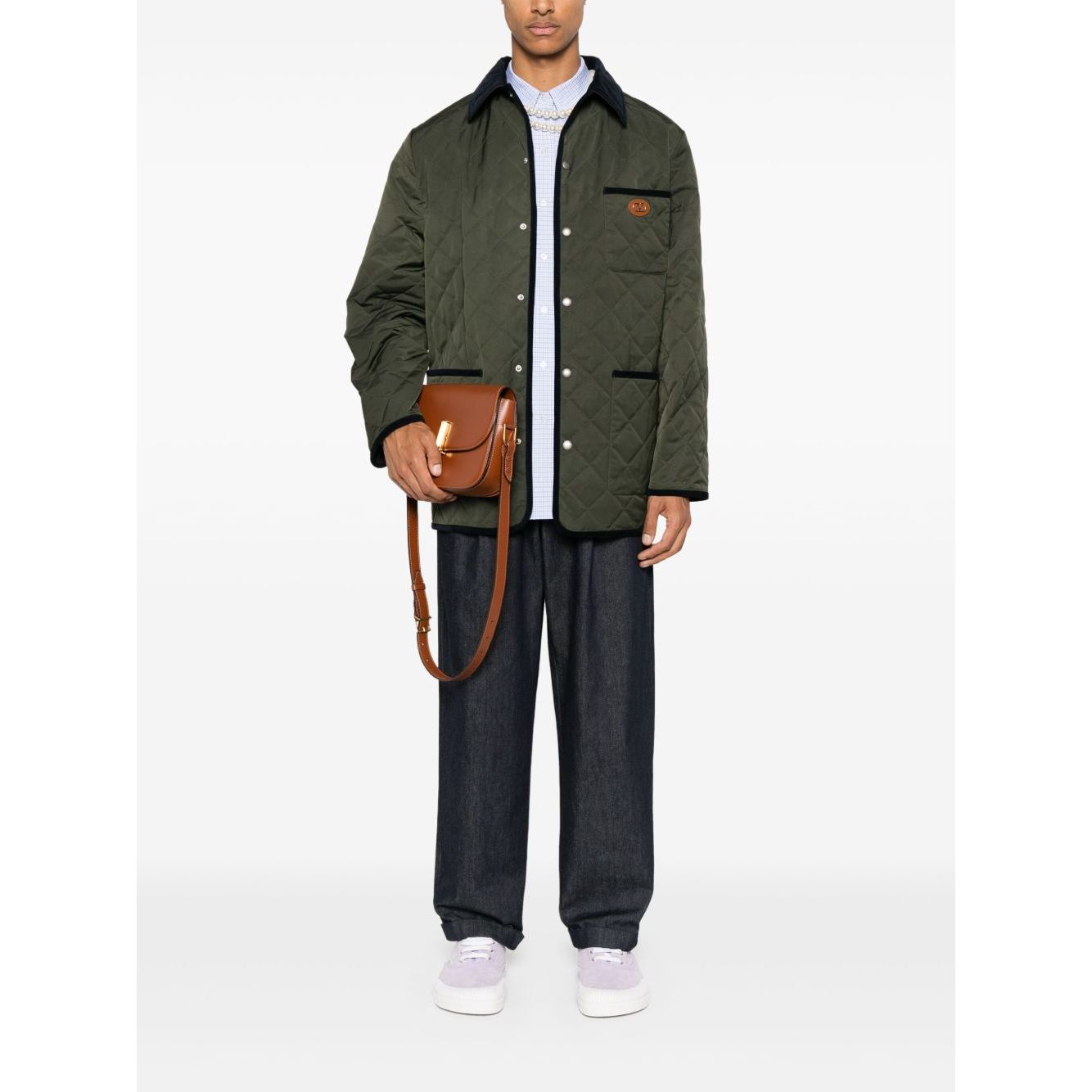 Valentino Vlogo Signature quilted jacket in olive green with contrasting collar and patch pockets, styled with casual pants.