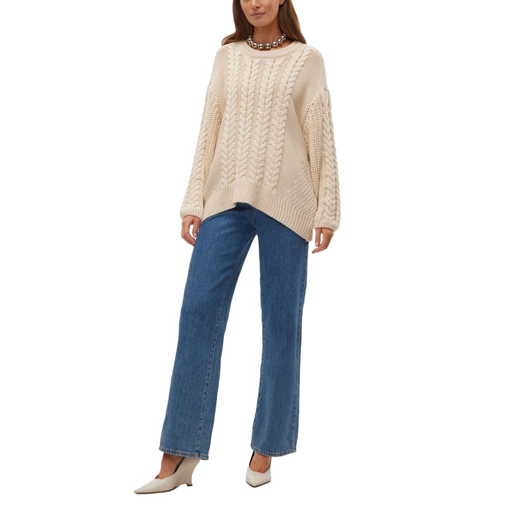 Woman wearing Vero Moda Beige Cotton Sweatshirt with cable-knit design, paired with blue jeans and white shoes.