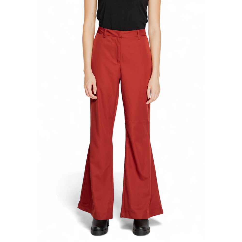 Woman wearing Vero Moda Red Polyester Flared Pants, showcasing mid-rise waist and wide leg cut for a sophisticated look.