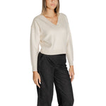 Woman wearing Vero Moda White Viscose Sweater with V-neckline and long sleeves, paired with black pants.