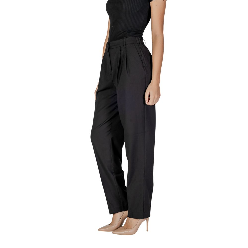 Woman wearing Vila Clothes Black Polyester Casual Pants with high waist and front pleats, styled with heels for a chic look.