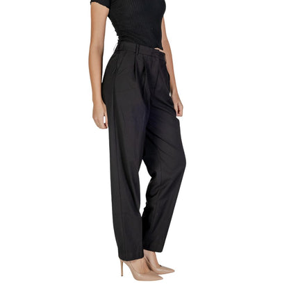 Woman wearing Vila Clothes Black Polyester Casual Pants with high waist, front pleats, and regular fit, showcasing contemporary elegance.
