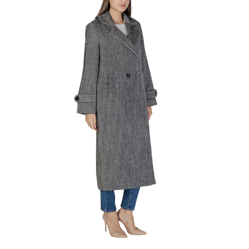 Woman wearing Vila Clothes Black Polyester Coat with wide lapels and large buttons, showcasing timeless elegance and warmth for colder seasons.