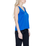 Side view of woman wearing Vila Clothes Blue Polyester Top with V-neck and adjustable straps, showcasing its fluid silhouette for contemporary style.