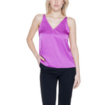 Woman wearing Vila Clothes Pink Polyester Top with V-neck and adjustable straps, enhancing a fluid and contemporary silhouette.