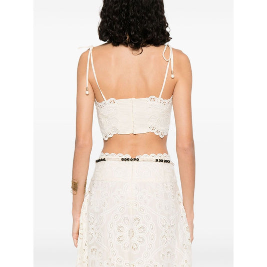 Zimmermann Cropped top featuring beige tie-fastening straps, cut-out floral detailing, and embroidered Rhiannon bodice with lettuce hem.