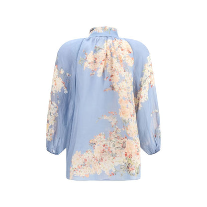Zimmermann Light Blue Ramie Blouse with floral print, featuring puff sleeves and lace detailing for a romantic and delicate look.
